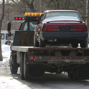 Tow truck carrying a vehicle